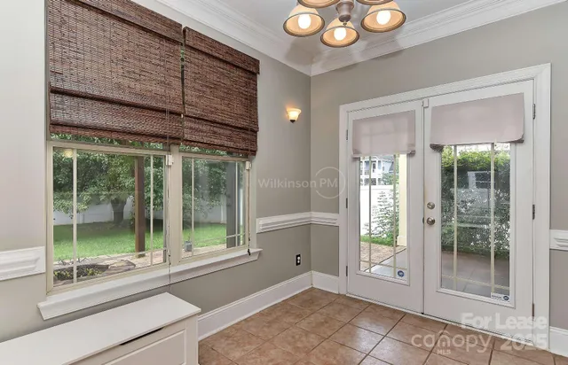 a view of a room with window and door