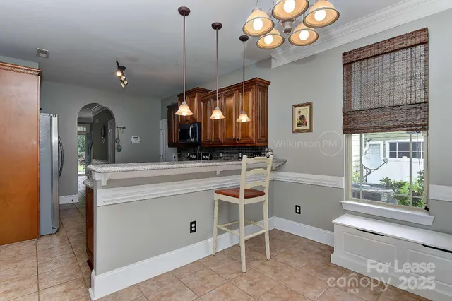 a view of a kitchen with a sink and dishwasher a fireplace with wooden floor