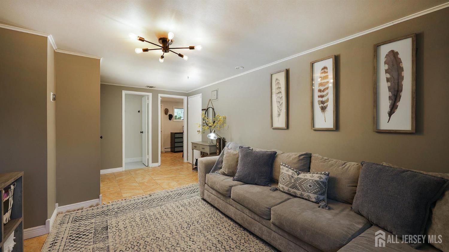 47 Miliken Road Colonia, NJ 07067 - Photo 23 of 40 a living room with furniture and a ceiling fan