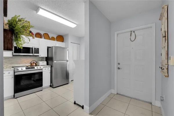 a kitchen with stainless steel appliances granite countertop a refrigerator and a stove