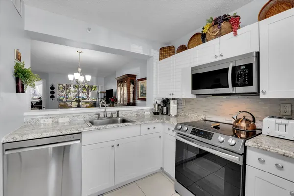 a kitchen with stainless steel appliances white cabinets and sink