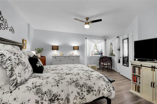 a bedroom with a bed and a flat screen tv