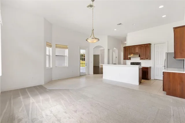 a kitchen with stainless steel appliances a refrigerator and a stove top oven