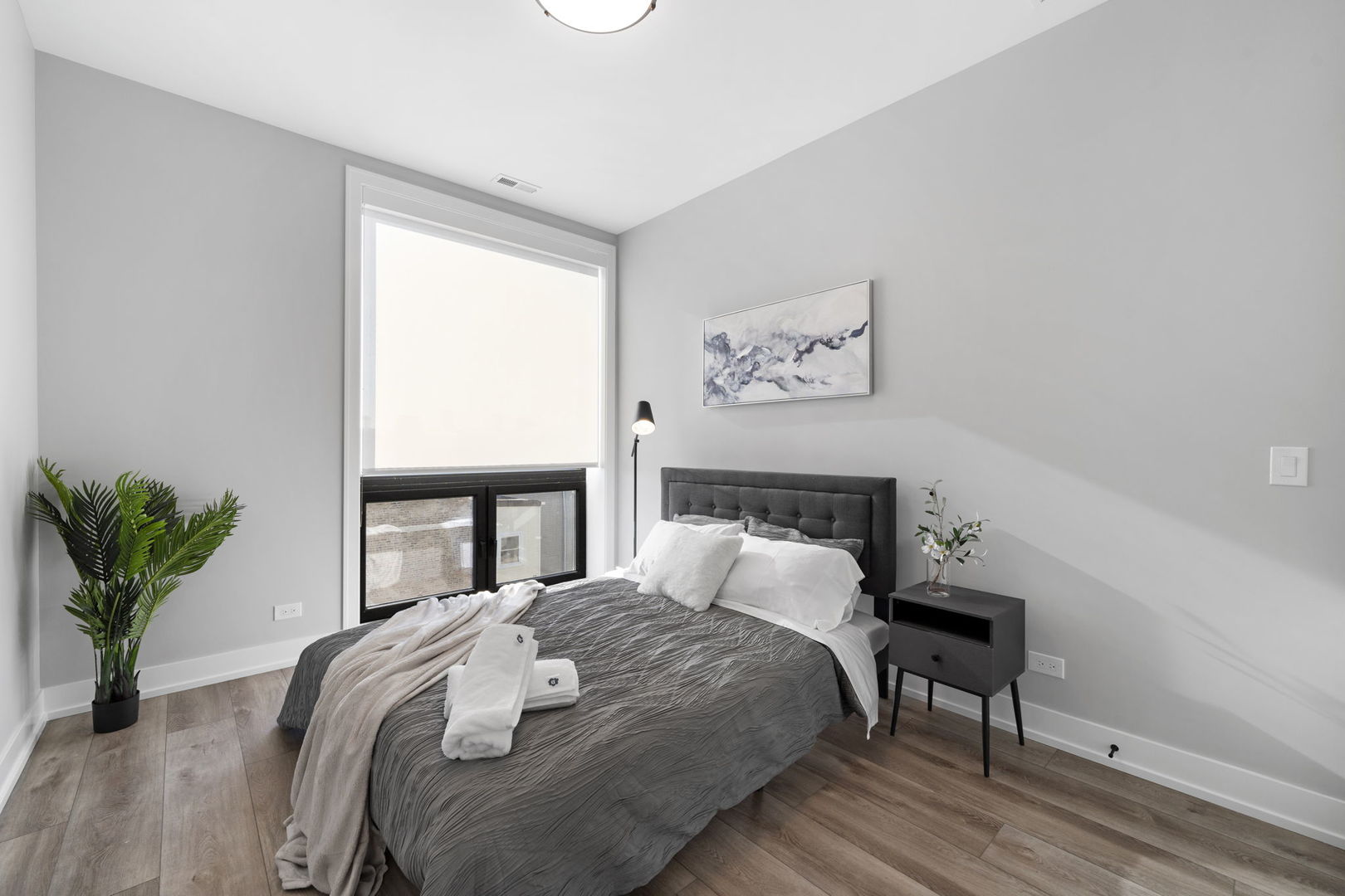 1606 South Ashland Avenue, Unit 401 Chicago, IL 60608 - Photo 15 of 25 a bedroom with a bed and a potted plant