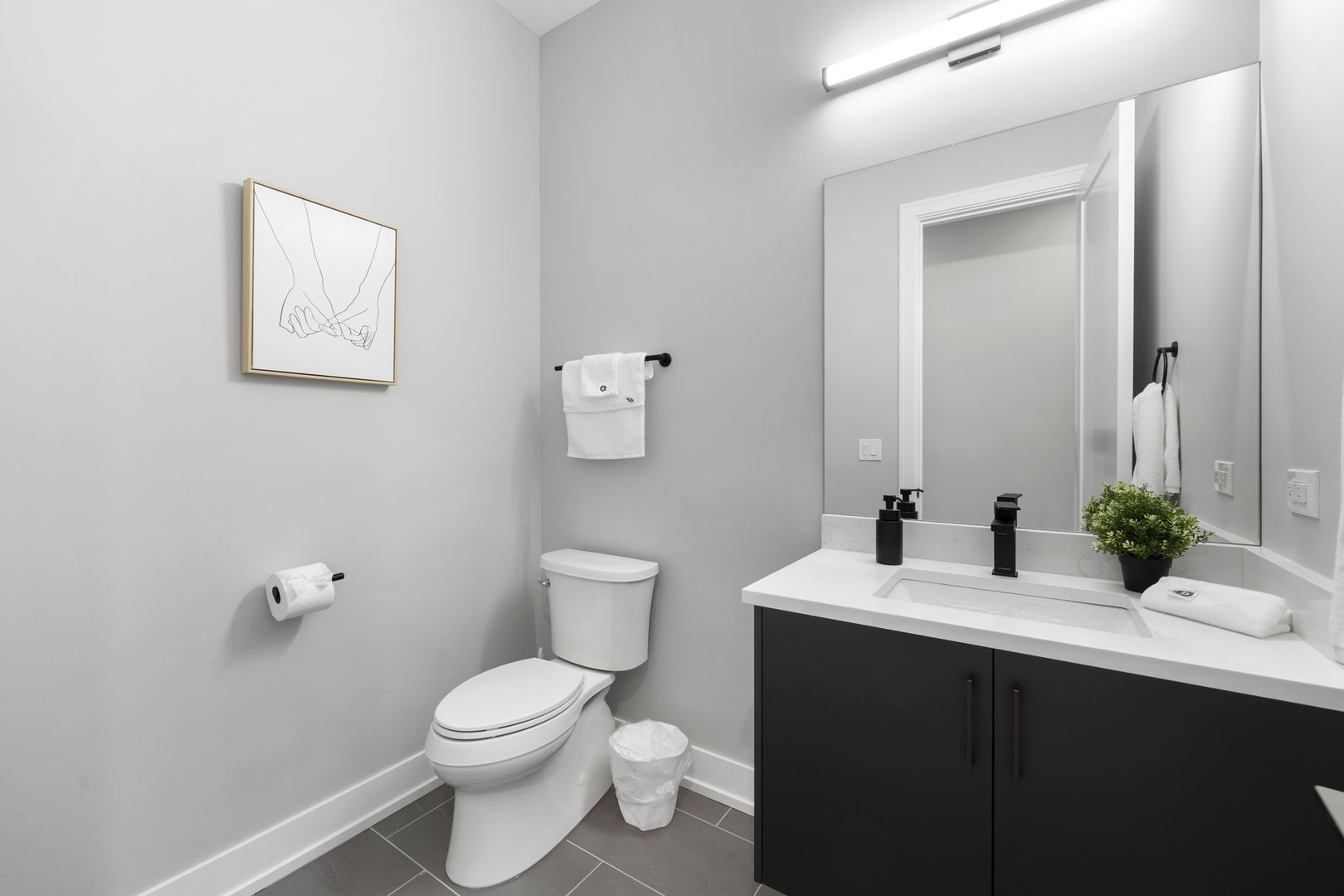 1606 South Ashland Avenue, Unit 401 Chicago, IL 60608 - Photo 17 of 25 a bathroom with a sink vanity mirror and toilet