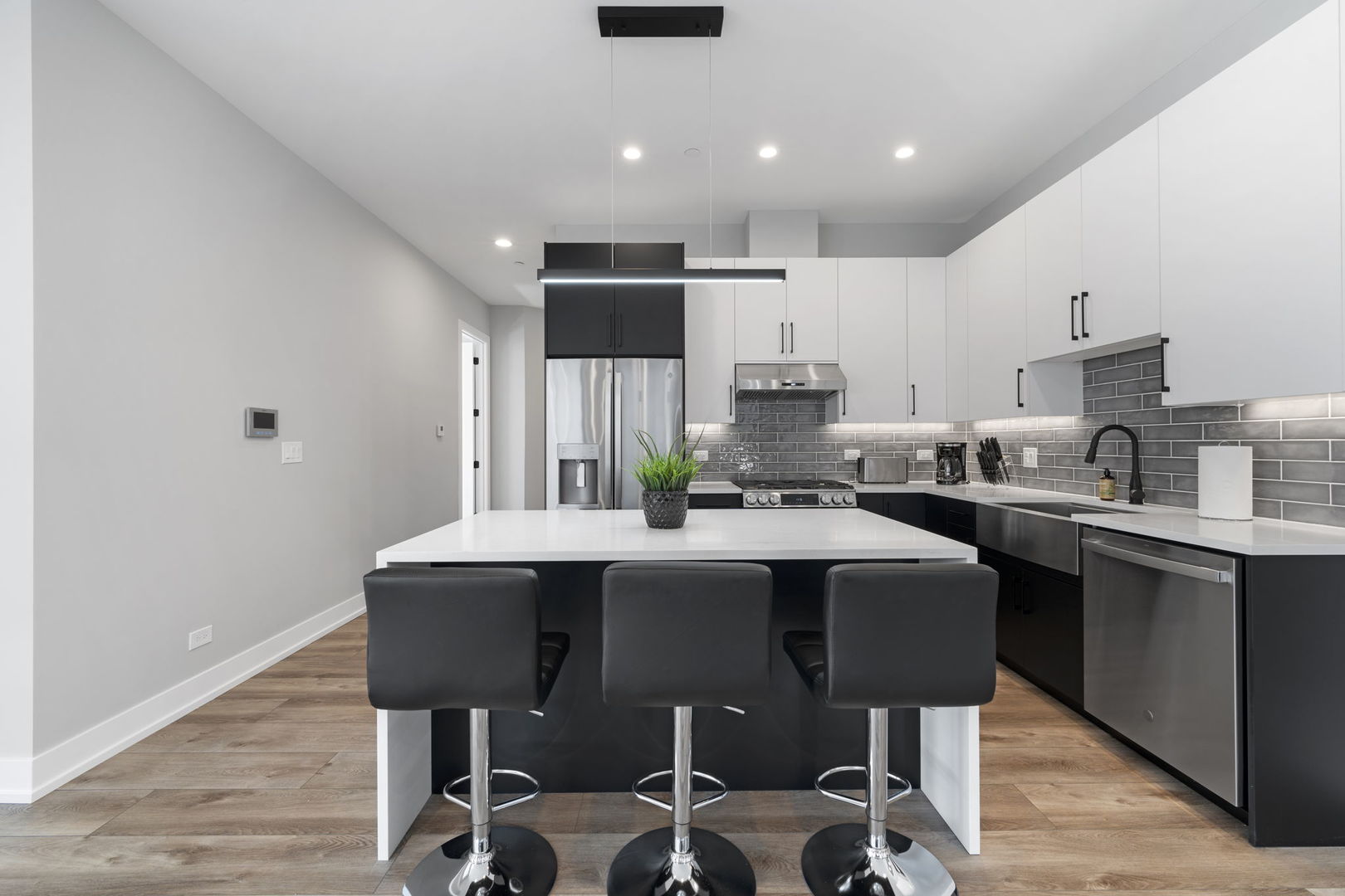 1606 South Ashland Avenue, Unit 401 Chicago, IL 60608 - Photo 3 of 25 a kitchen with a table chairs sink and cabinets