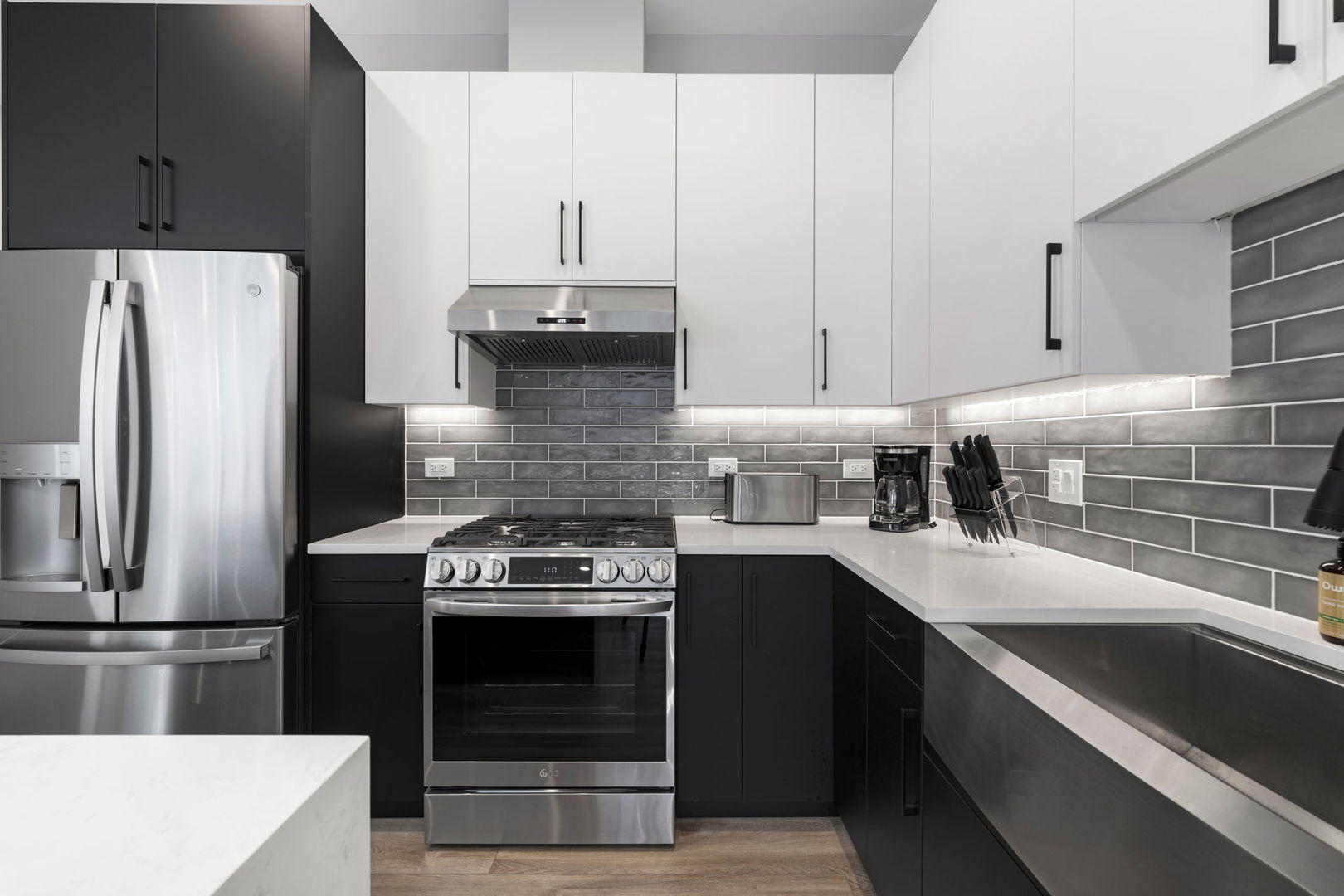 1606 South Ashland Avenue, Unit 401 Chicago, IL 60608 - Photo 4 of 25 a kitchen with stainless steel appliances a stove a sink and a refrigerator
