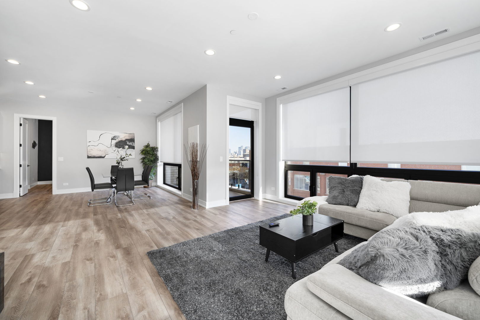 1606 South Ashland Avenue, Unit 401 Chicago, IL 60608 - Photo 8 of 25 a living room with furniture and a chandelier