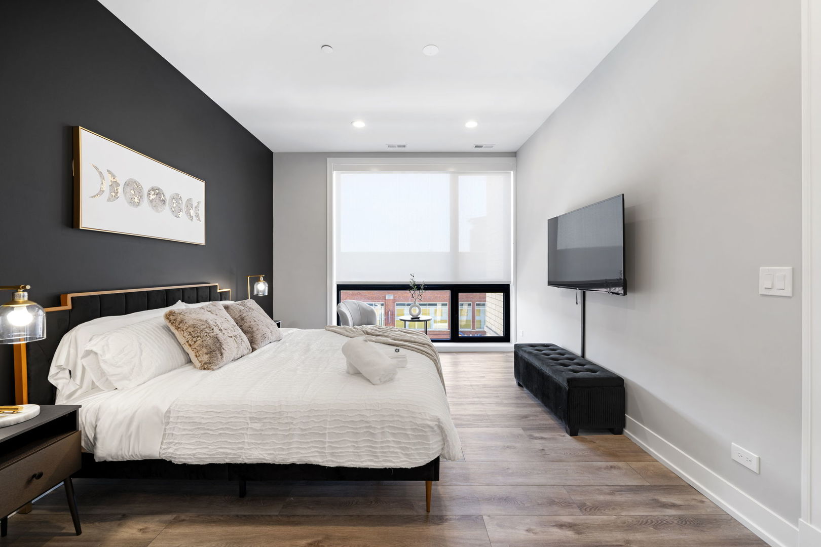 1606 South Ashland Avenue, Unit 401 Chicago, IL 60608 - Photo 10 of 25 a bedroom with a bed and a flat screen tv