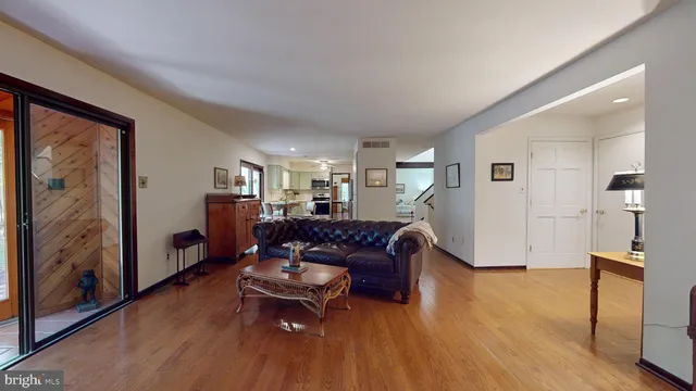 a kitchen with stainless steel appliances a sink cabinets and wooden floor