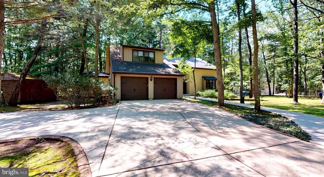 a front view of a house with a yard and a garage