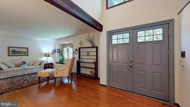 a living room with furniture rug and window
