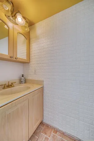 a bathroom with a sink a toilet and mirror