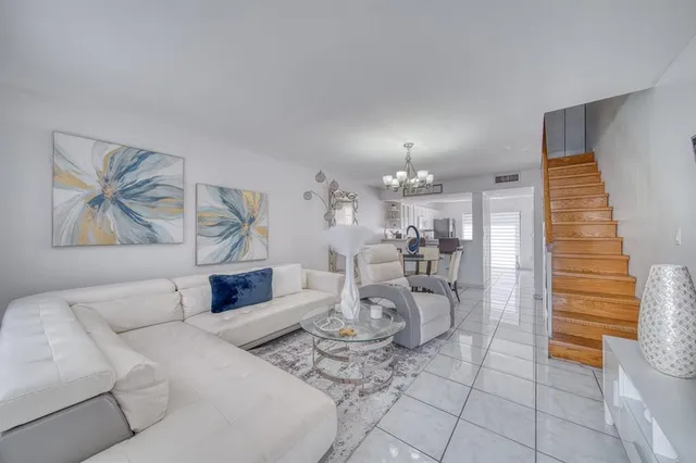 a kitchen with white cabinets and refrigerator