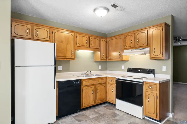 a kitchen with a sink stove and refrigerator
