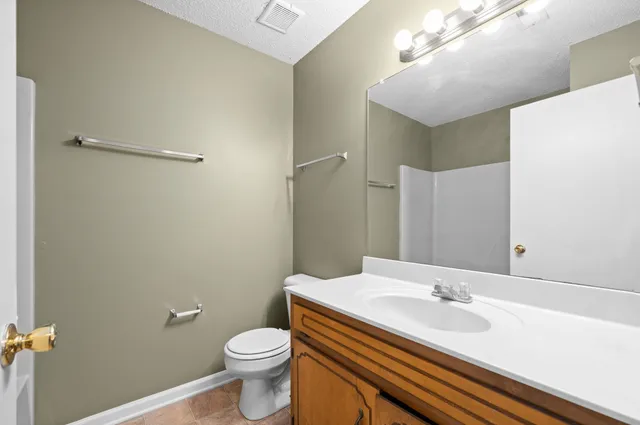 a bathroom with a sink a toilet and mirror