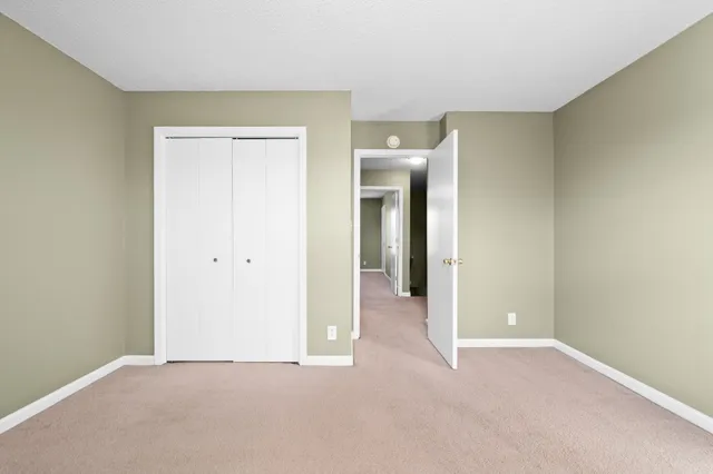 a view of an empty room and closet area