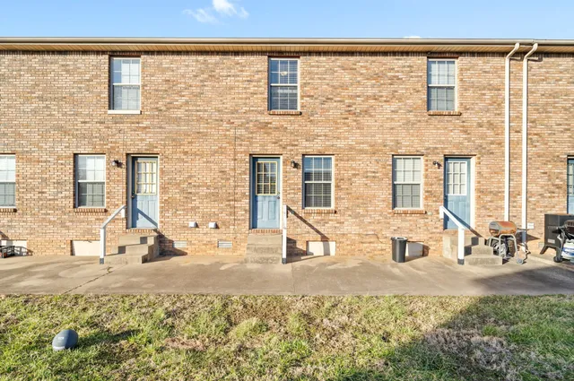 a view of a brick house with many windows