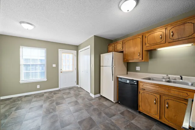 a kitchen with a stove a sink and a refrigerator