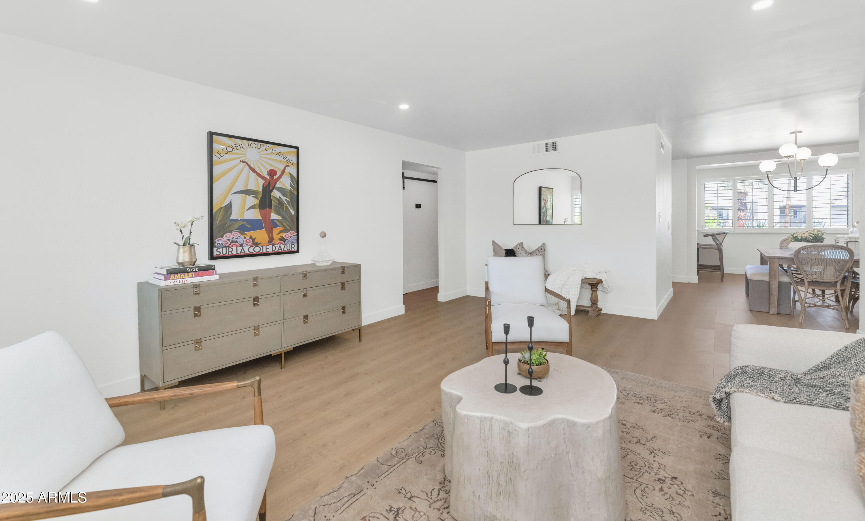4201 East Camelback Road, Unit 70 Phoenix, AZ 85018 - Photo 12 of 36 a living room with furniture and a wooden floor