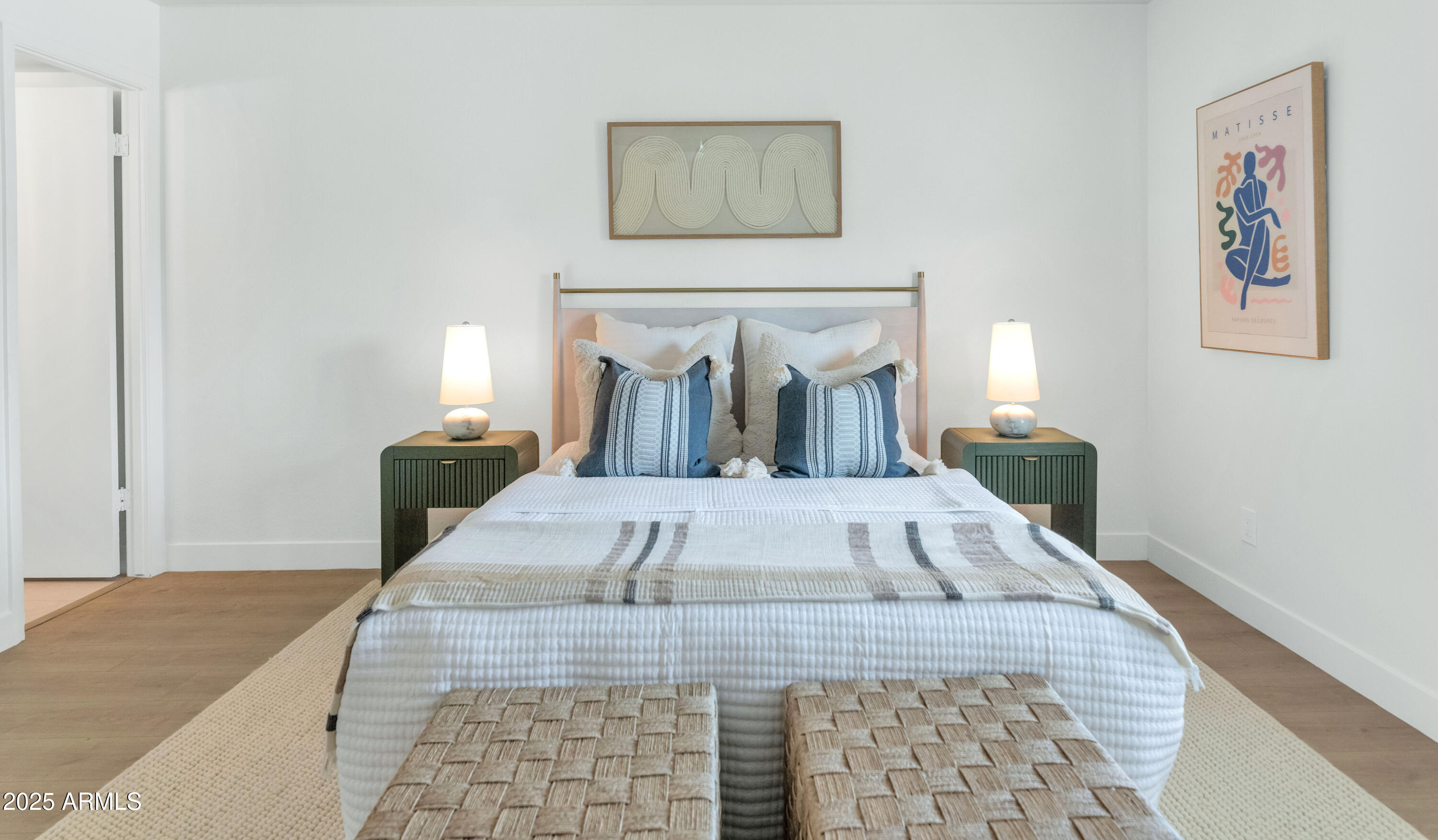 4201 East Camelback Road, Unit 70 Phoenix, AZ 85018 - Photo 19 of 36 a view of a bedroom with wooden floor and bedroom