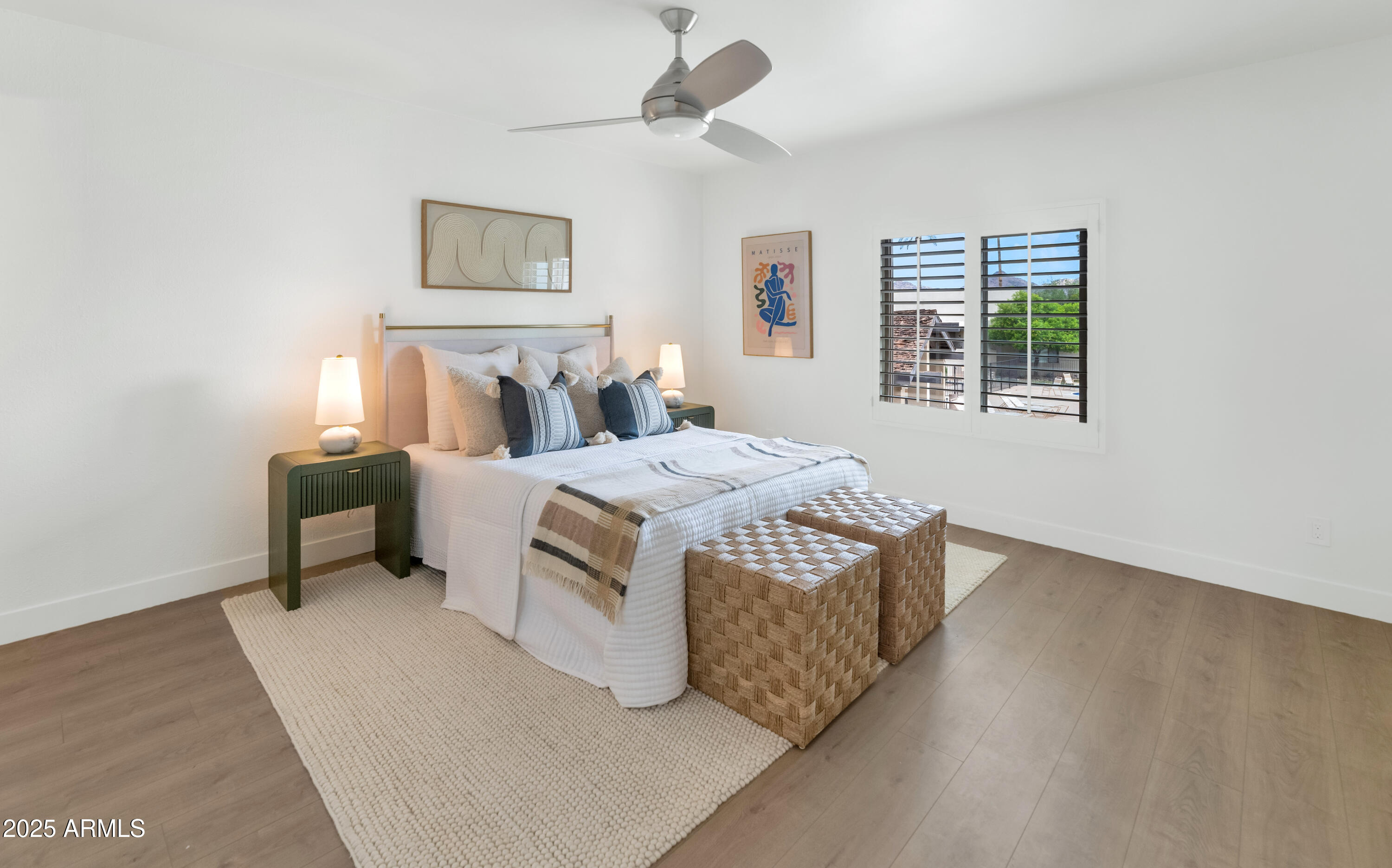 4201 East Camelback Road, Unit 70 Phoenix, AZ 85018 - Photo 20 of 36 a living room with a bed furniture and a window