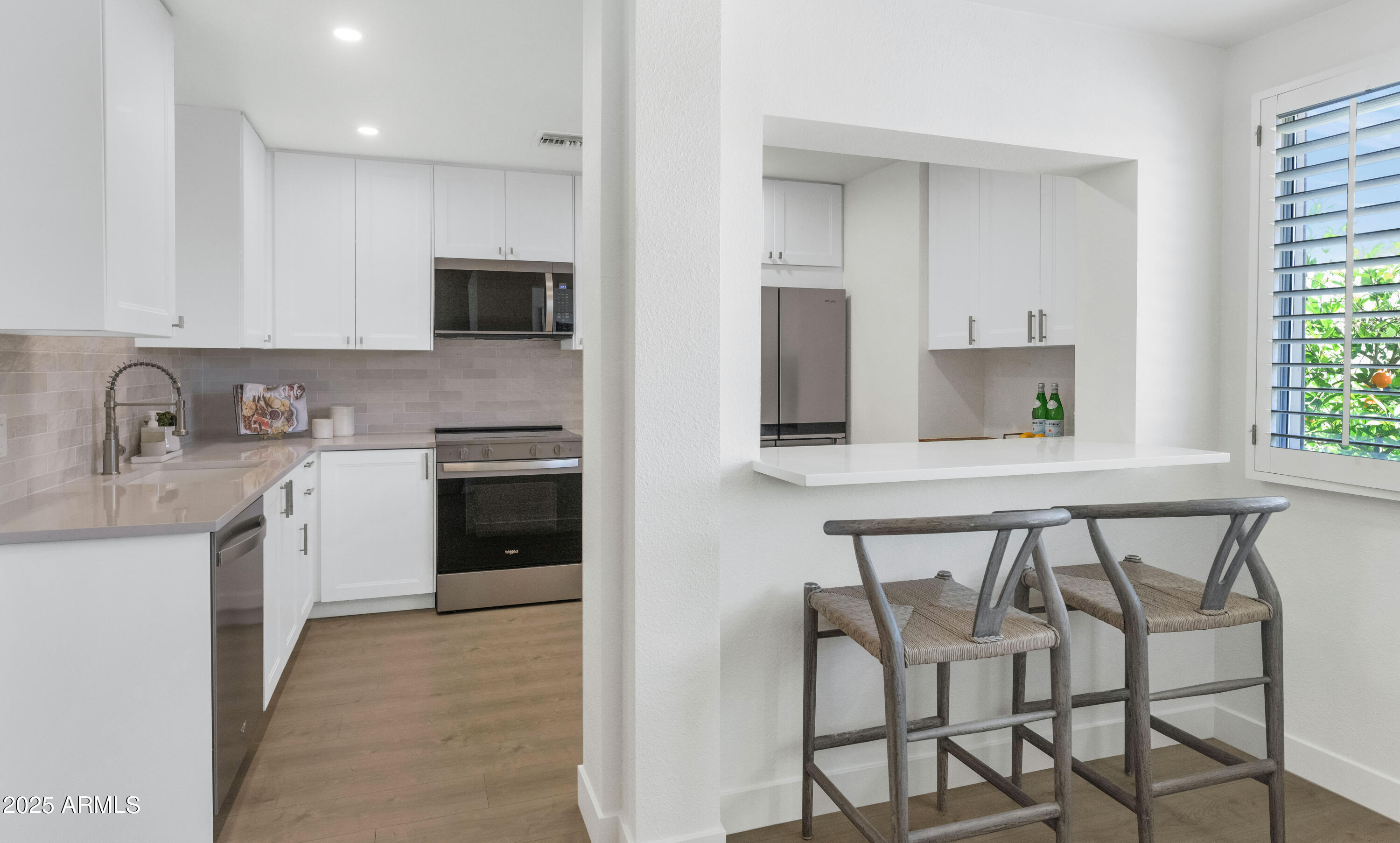 4201 East Camelback Road, Unit 70 Phoenix, AZ 85018 - Photo 2 of 36 a kitchen with a table chairs sink and cabinets