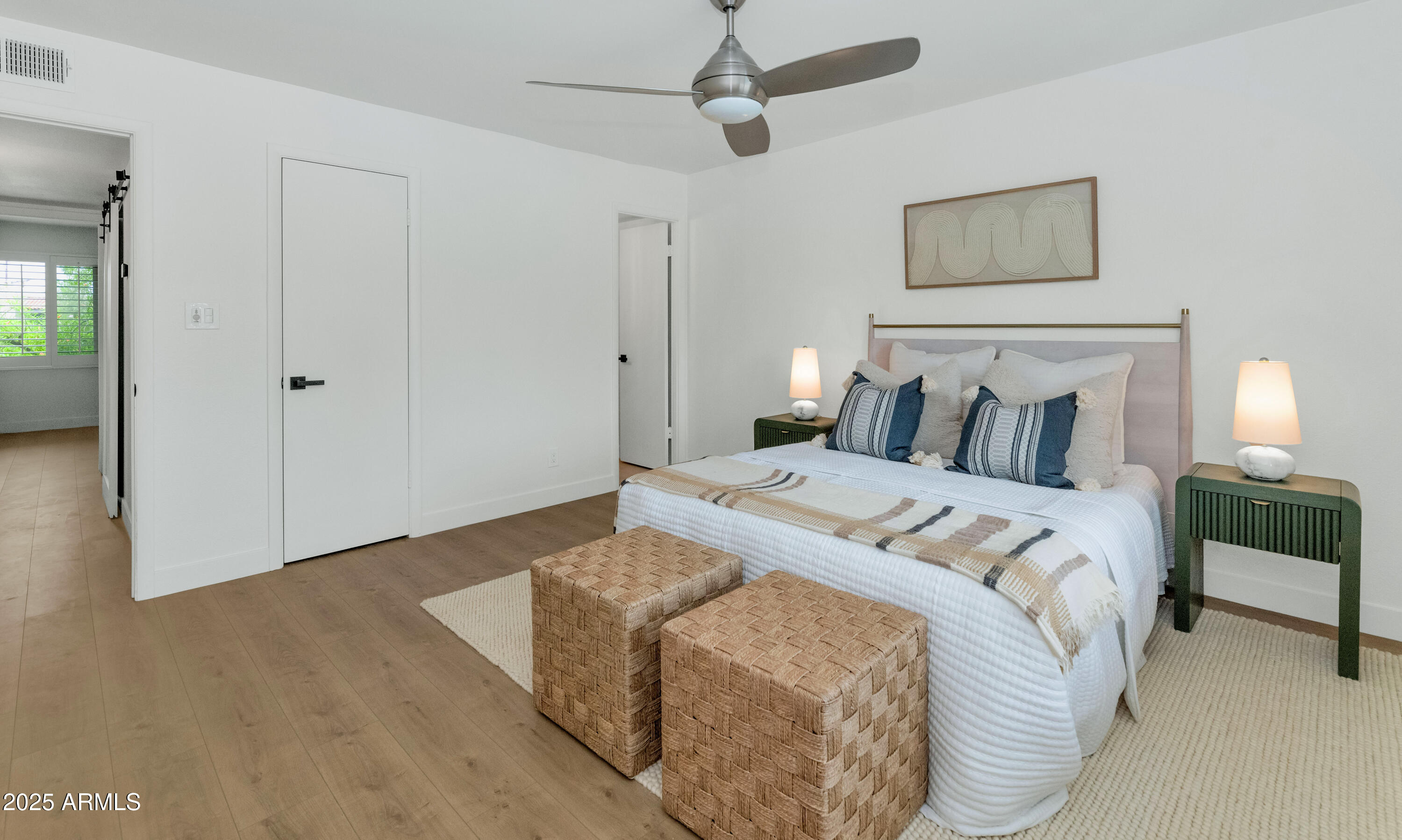 4201 East Camelback Road, Unit 70 Phoenix, AZ 85018 - Photo 21 of 36 a bedroom with a bed and a chandelier