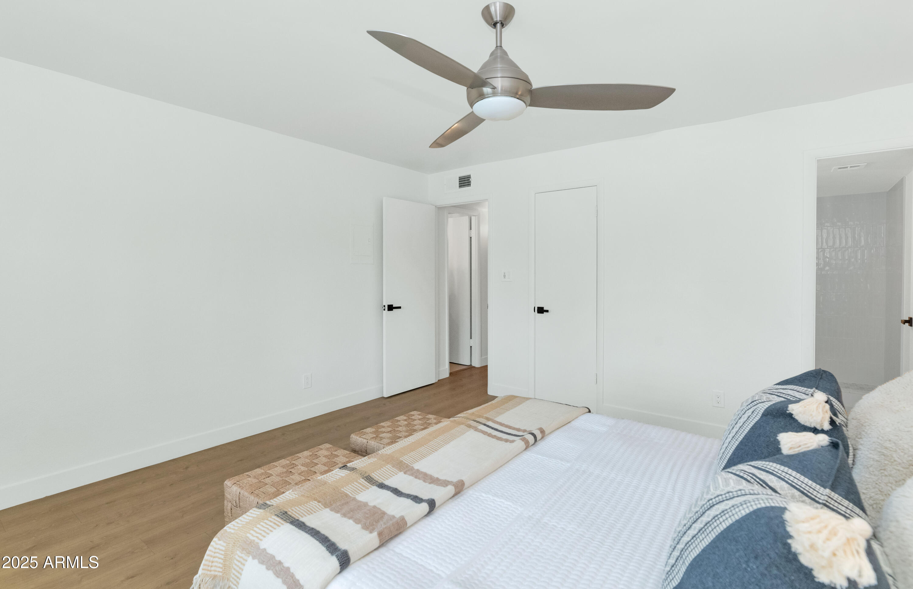 4201 East Camelback Road, Unit 70 Phoenix, AZ 85018 - Photo 22 of 36 a bedroom with a bed and a chandelier