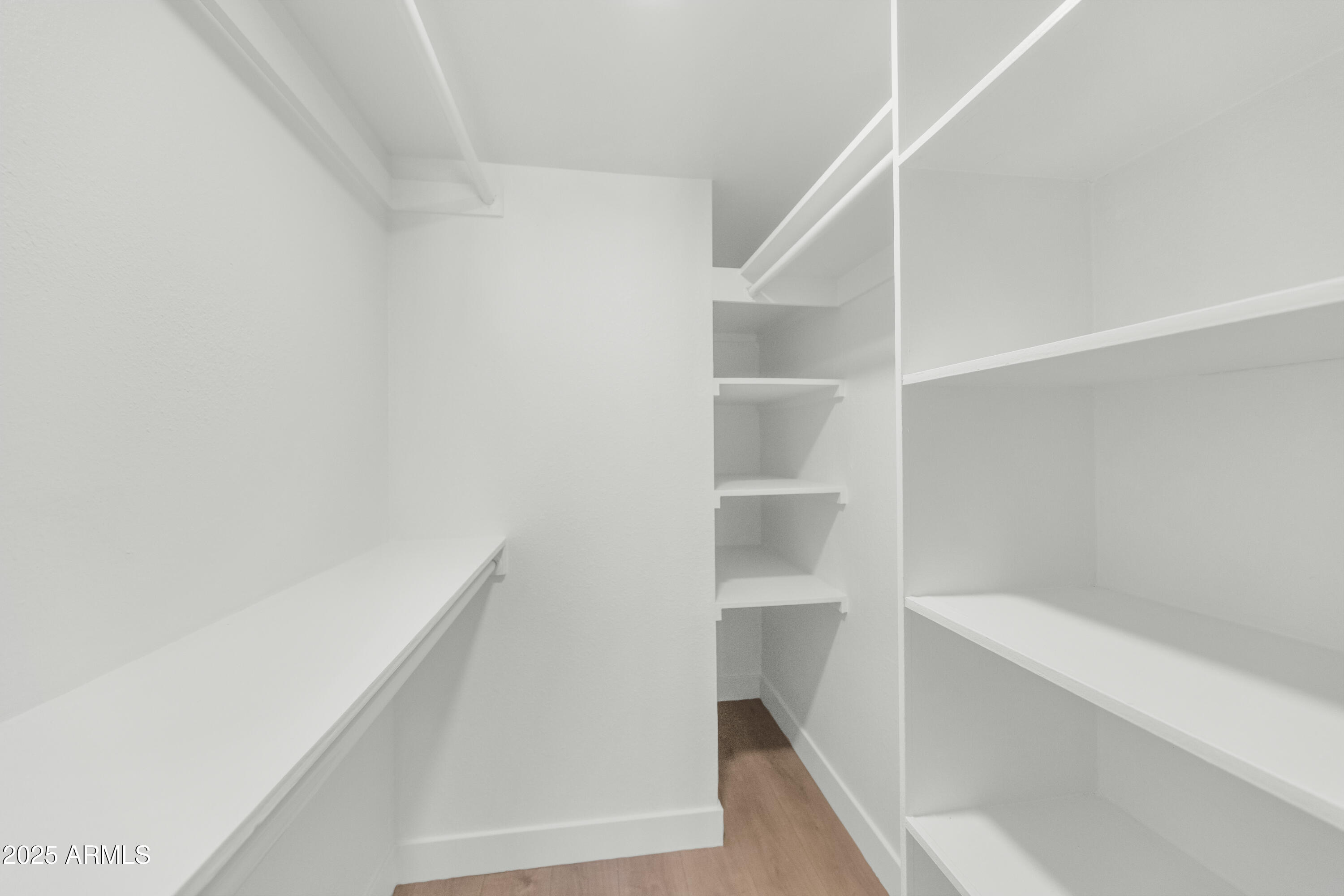 4201 East Camelback Road, Unit 70 Phoenix, AZ 85018 - Photo 23 of 36 a view of walk in closet with empty racks