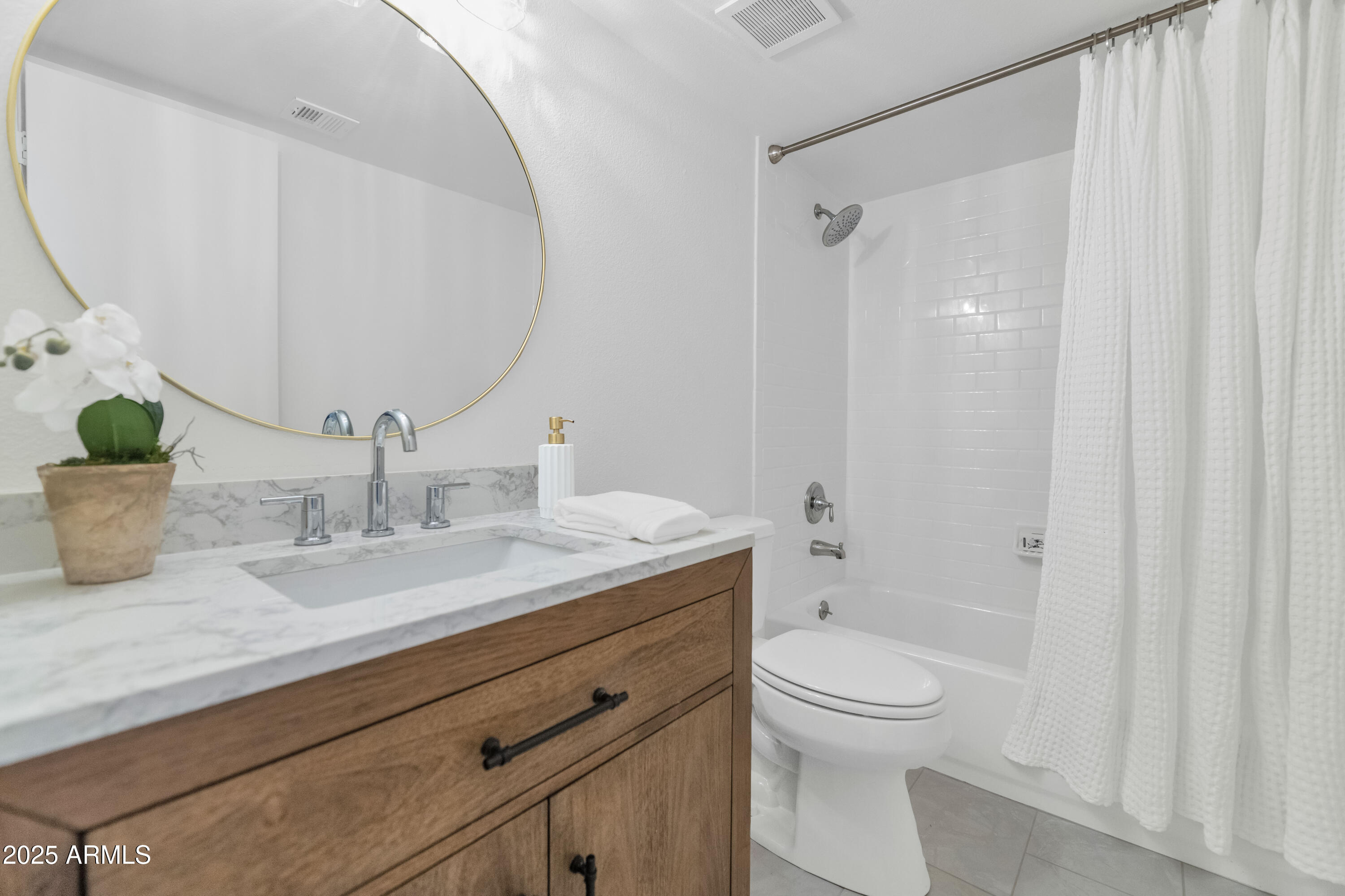 4201 East Camelback Road, Unit 70 Phoenix, AZ 85018 - Photo 28 of 36 a bathroom with a granite countertop sink a toilet and a mirror