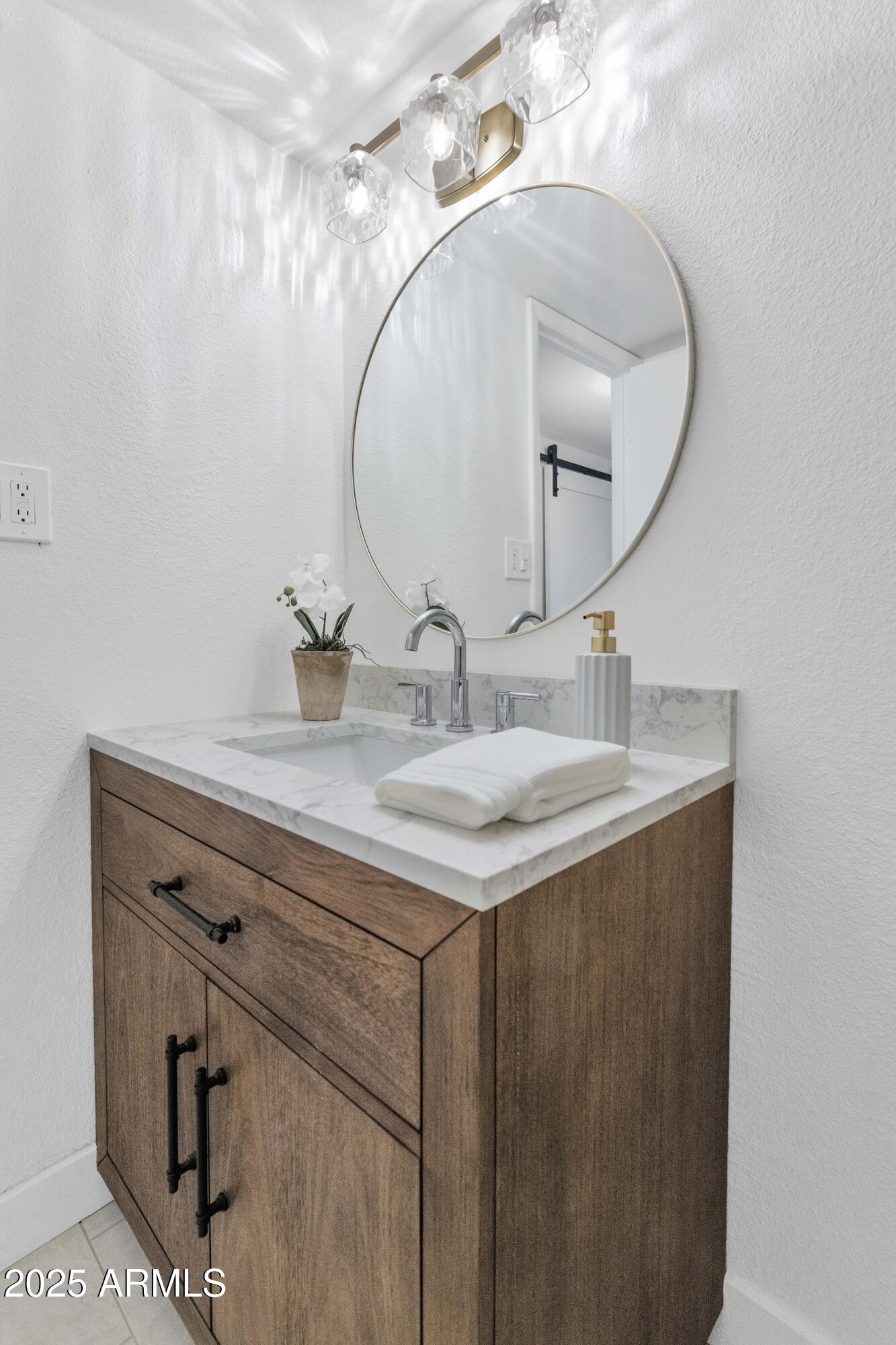 4201 East Camelback Road, Unit 70 Phoenix, AZ 85018 - Photo 29 of 36 a bathroom with a sink vanity and a mirror