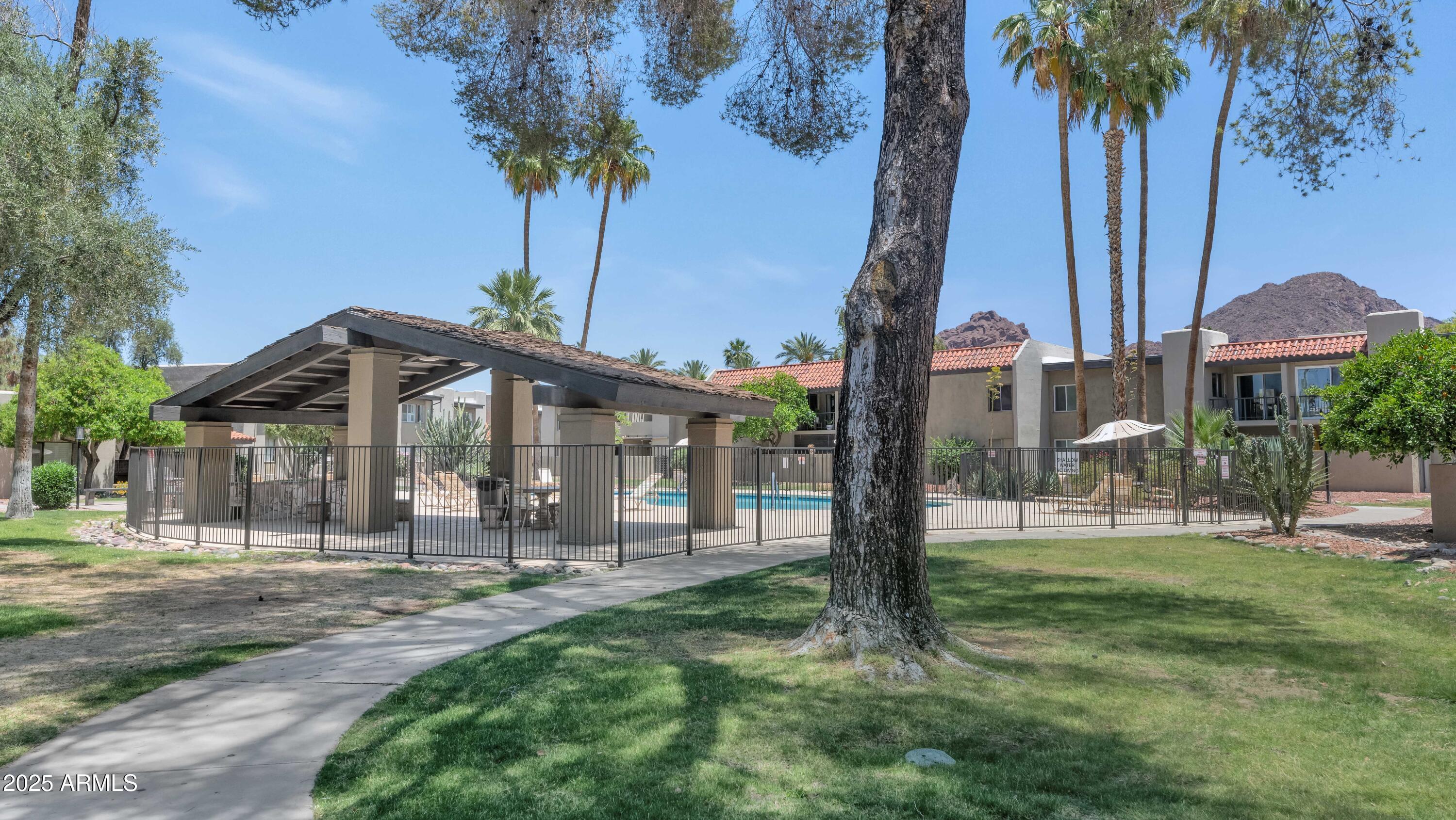 4201 East Camelback Road, Unit 70 Phoenix, AZ 85018 - Photo 33 of 36 a front view of a house with garden and trees
