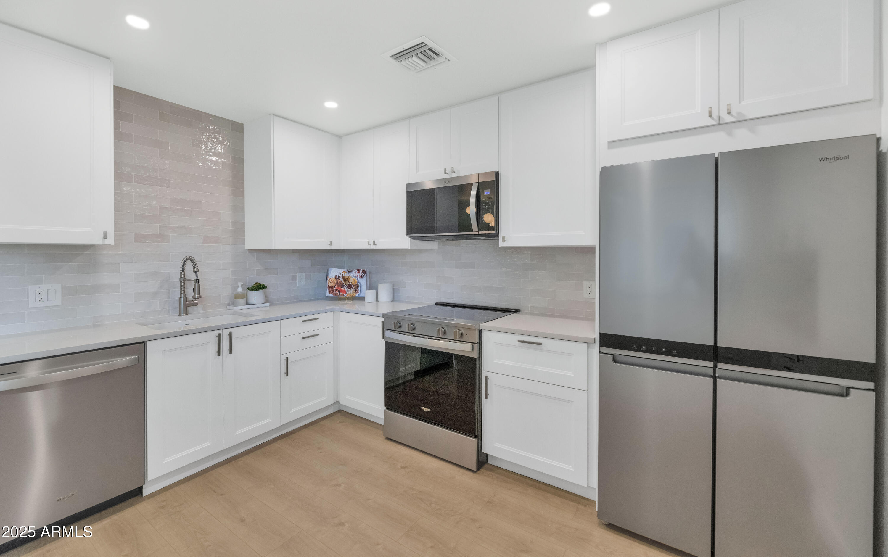 4201 East Camelback Road, Unit 70 Phoenix, AZ 85018 - Photo 5 of 36 a kitchen with cabinets stainless steel appliances and sink
