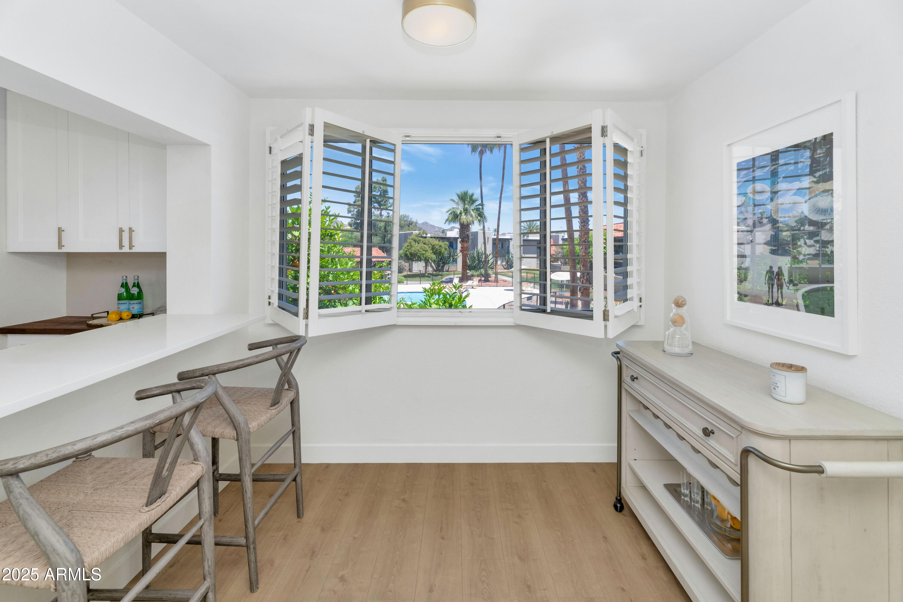 4201 East Camelback Road, Unit 70 Phoenix, AZ 85018 - Photo 7 of 36 a kitchen with a table chairs sink and cabinets