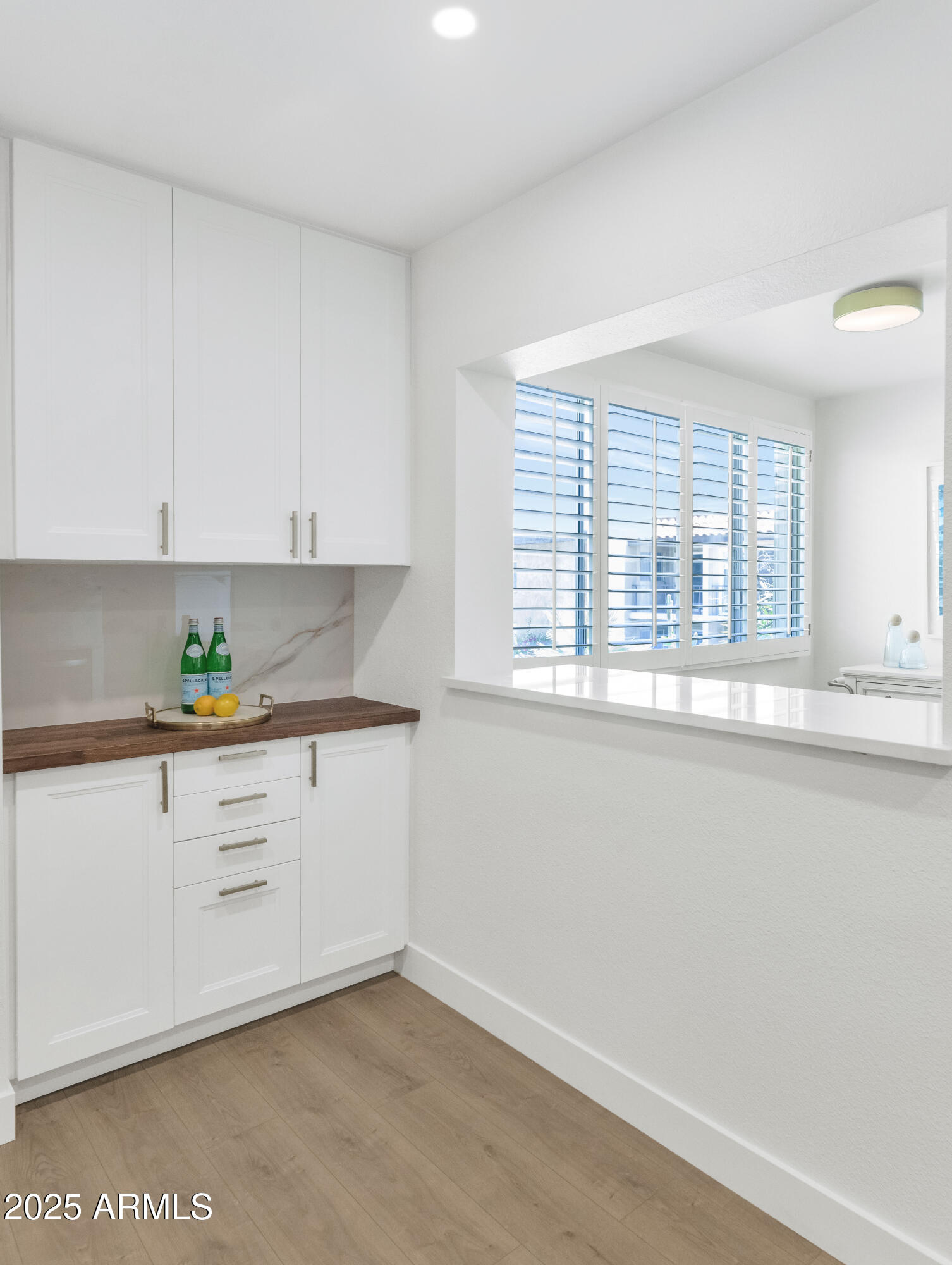 4201 East Camelback Road, Unit 70 Phoenix, AZ 85018 - Photo 8 of 36 a kitchen with granite countertop white cabinets and a window