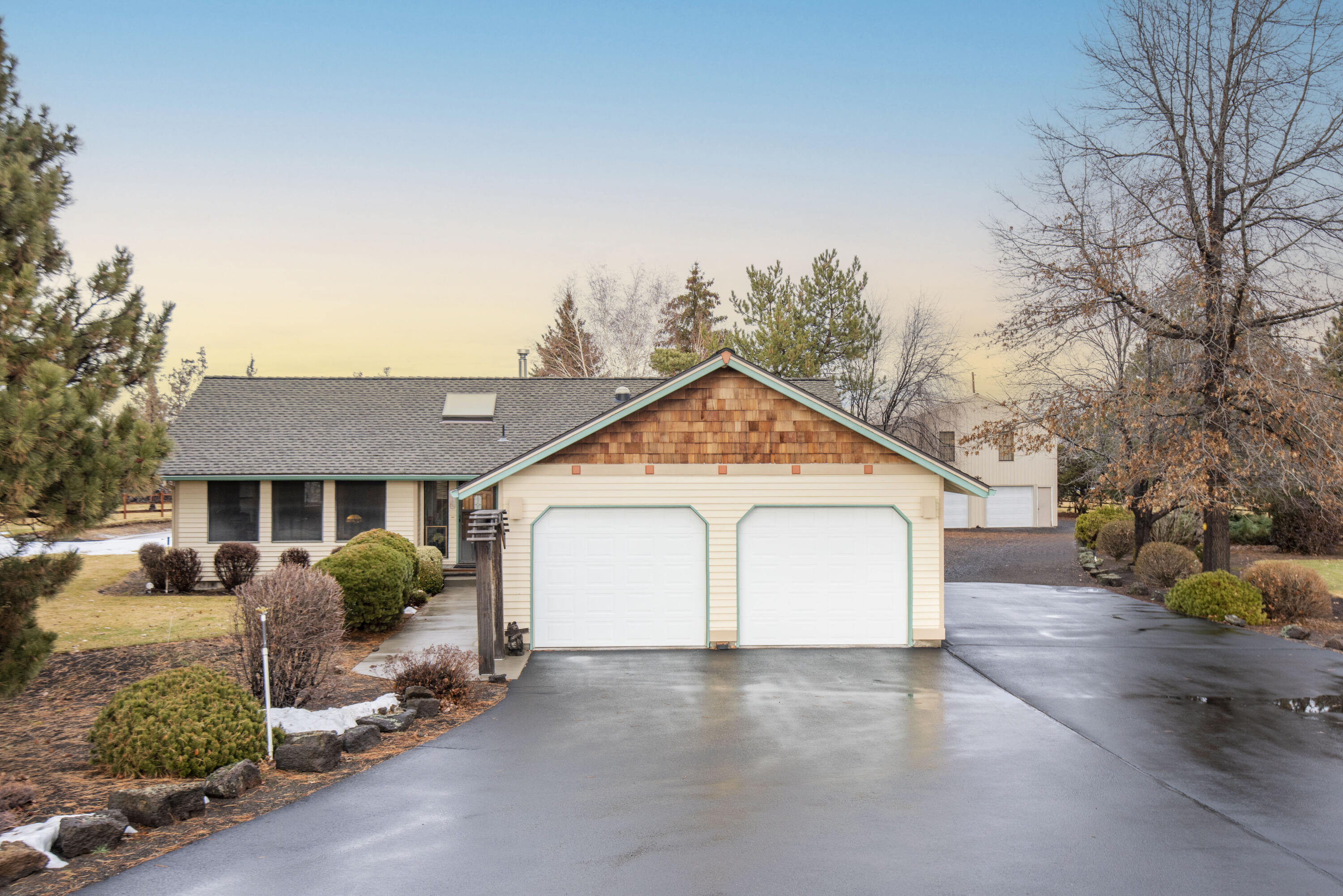 22252 Nelson Road Bend, OR 97701 - Photo 1 of 21 a view of a house with a yard and garage