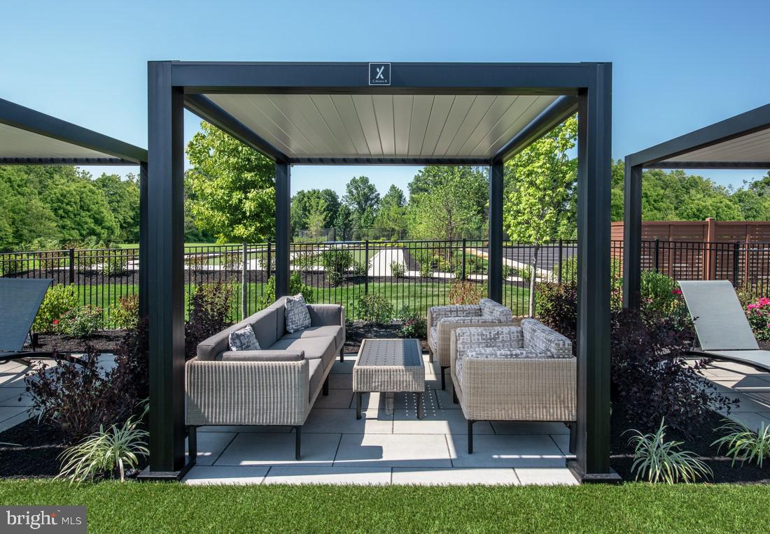 214 Gerry Way, Unit 249 Ambler, PA 19002 - Photo 13 of 38 a view of a patio with couches potted plants and a big yard