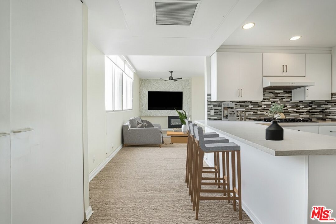 17350 Sunset Boulevard, Unit PH2 Pacific Palisades, CA 90272 - Photo 25 of 36 a view of living room with furniture and flat screen tv