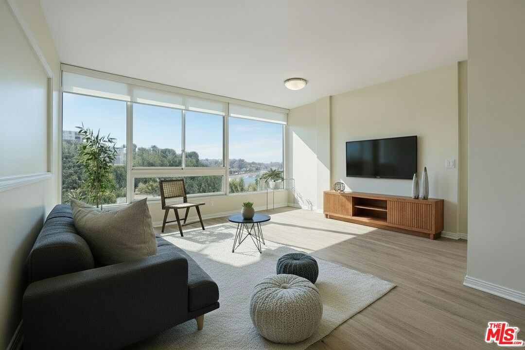 17350 Sunset Boulevard, Unit PH2 Pacific Palisades, CA 90272 - Photo 30 of 36 a living room with furniture and a flat screen tv