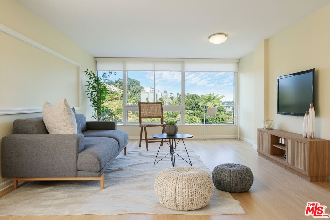 17350 Sunset Boulevard, Unit PH2 Pacific Palisades, CA 90272 - Photo 3 of 36 a living room with furniture and a flat screen tv