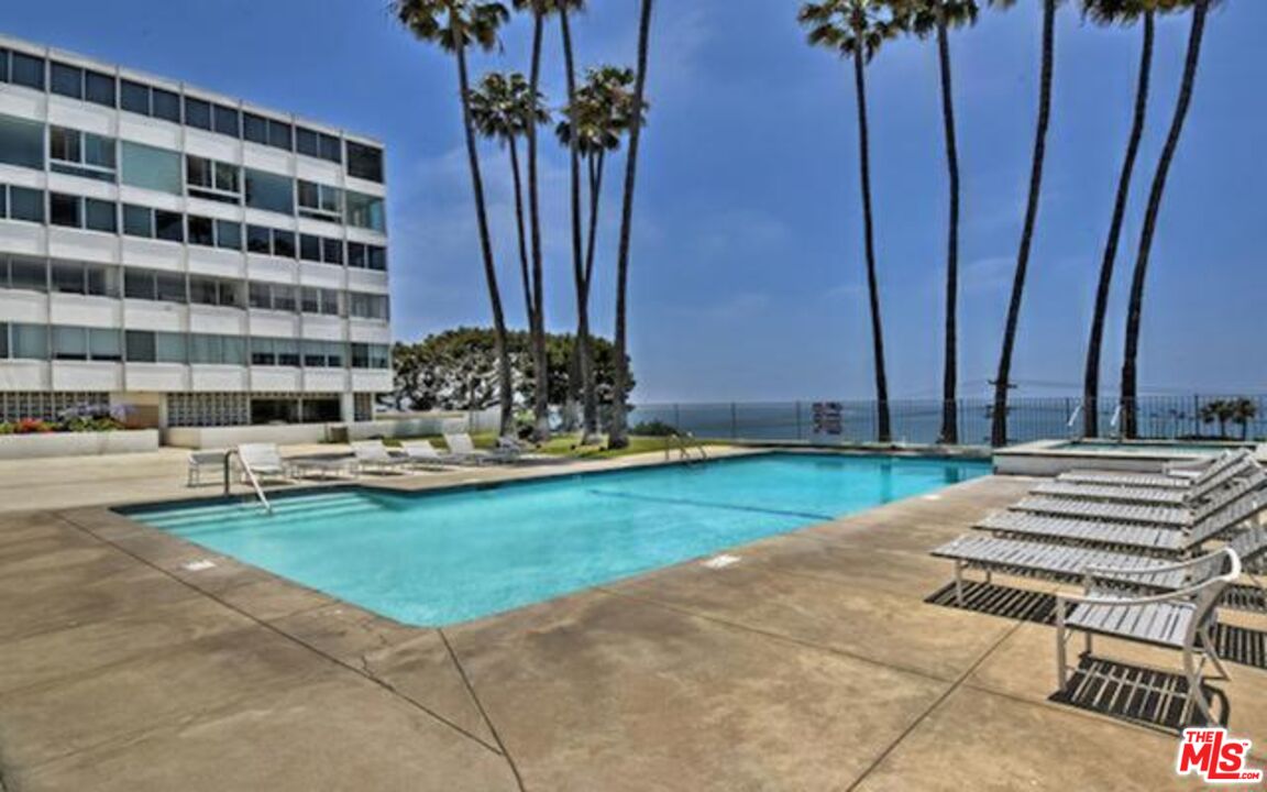 17350 Sunset Boulevard, Unit PH2 Pacific Palisades, CA 90272 - Photo 32 of 36 a view of a patio with a table and chairs