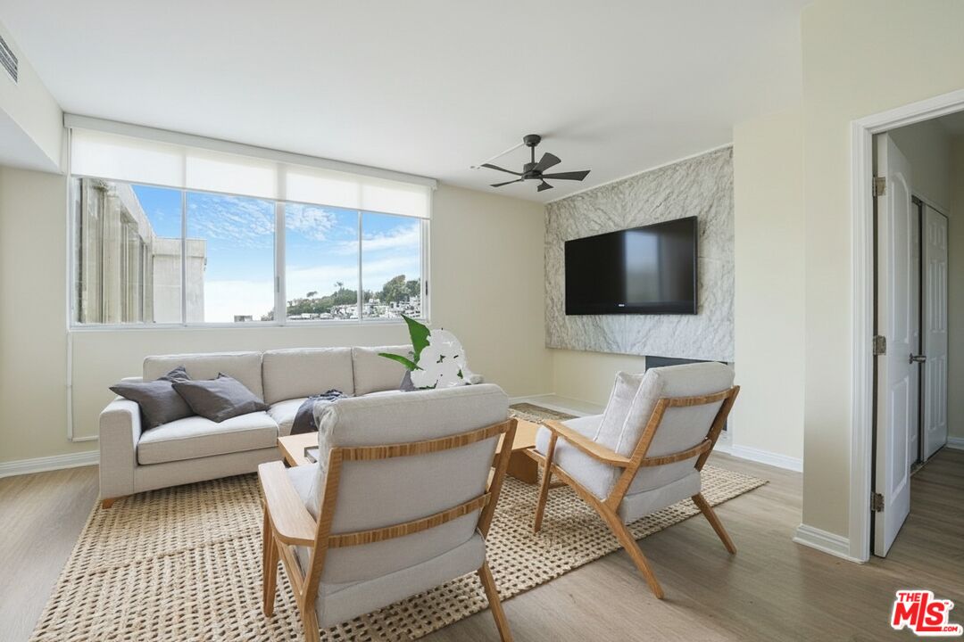 17350 Sunset Boulevard, Unit PH2 Pacific Palisades, CA 90272 - Photo 34 of 36 a living room with furniture and a flat screen tv