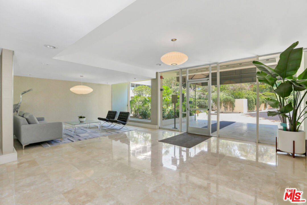 17350 Sunset Boulevard, Unit PH2 Pacific Palisades, CA 90272 - Photo 35 of 36 a view of a livingroom with furniture and floor to ceiling window
