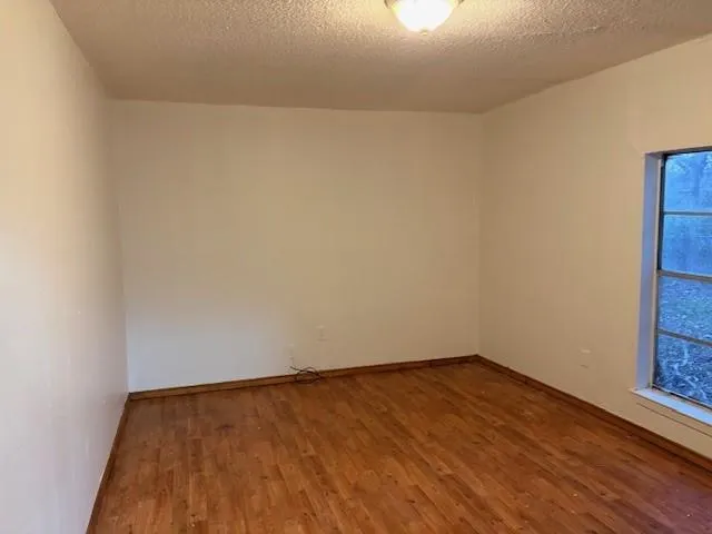 a view of an empty room and wooden floor