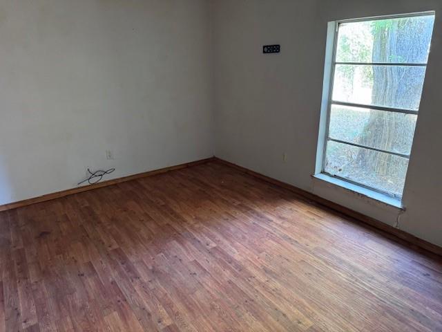 1343 Hillard Street Paris, TX 75460 - Photo 6 of 10 Empty room with wood finished floors and baseboards