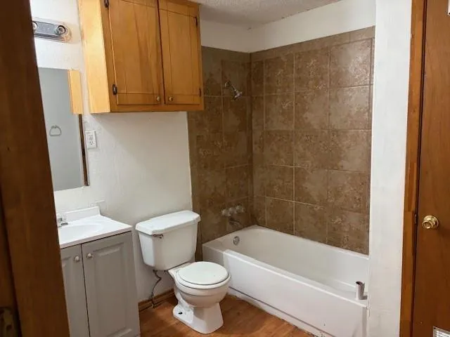 a white toilet sitting next to a bathtub