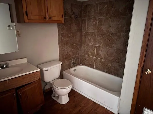 a white toilet sitting next to a bathtub