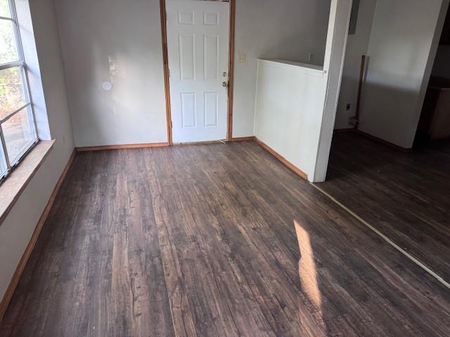 1343 Hillard Street Paris, TX 75460 - Photo 9 of 10 Empty room featuring dark wood-style floors and baseboards