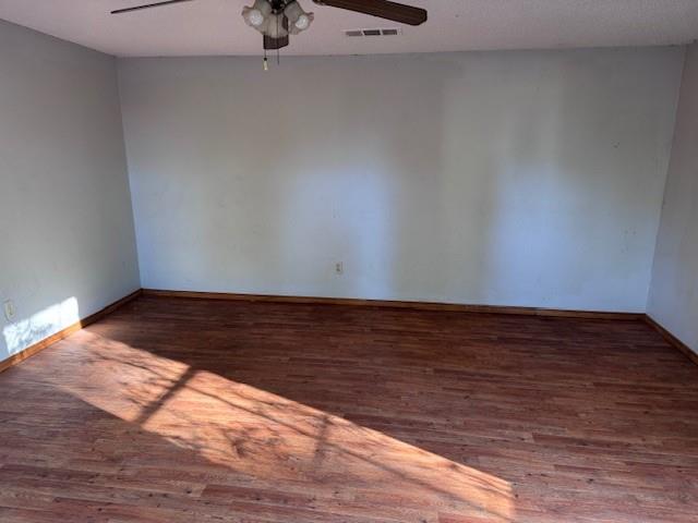 1343 Hillard Street Paris, TX 75460 - Photo 10 of 10 Empty room with a textured ceiling, dark wood finished floors, and a ceiling fan